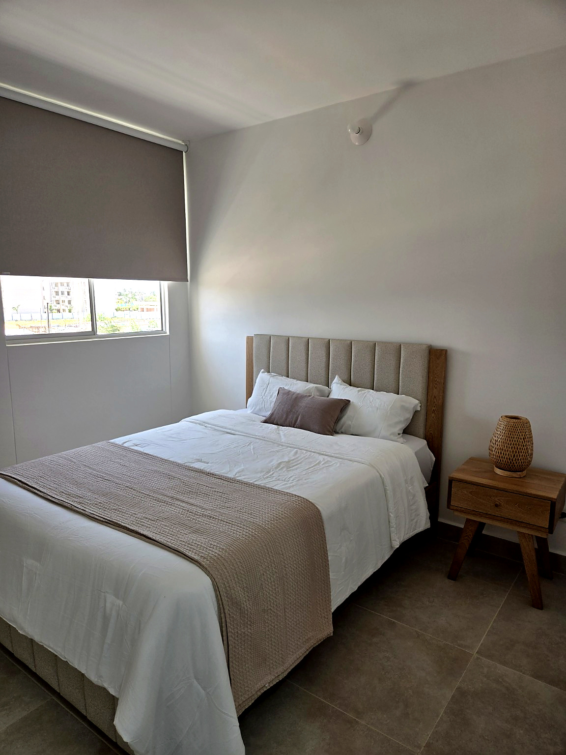 Another view of the Capriella bedroom with nightstand and window