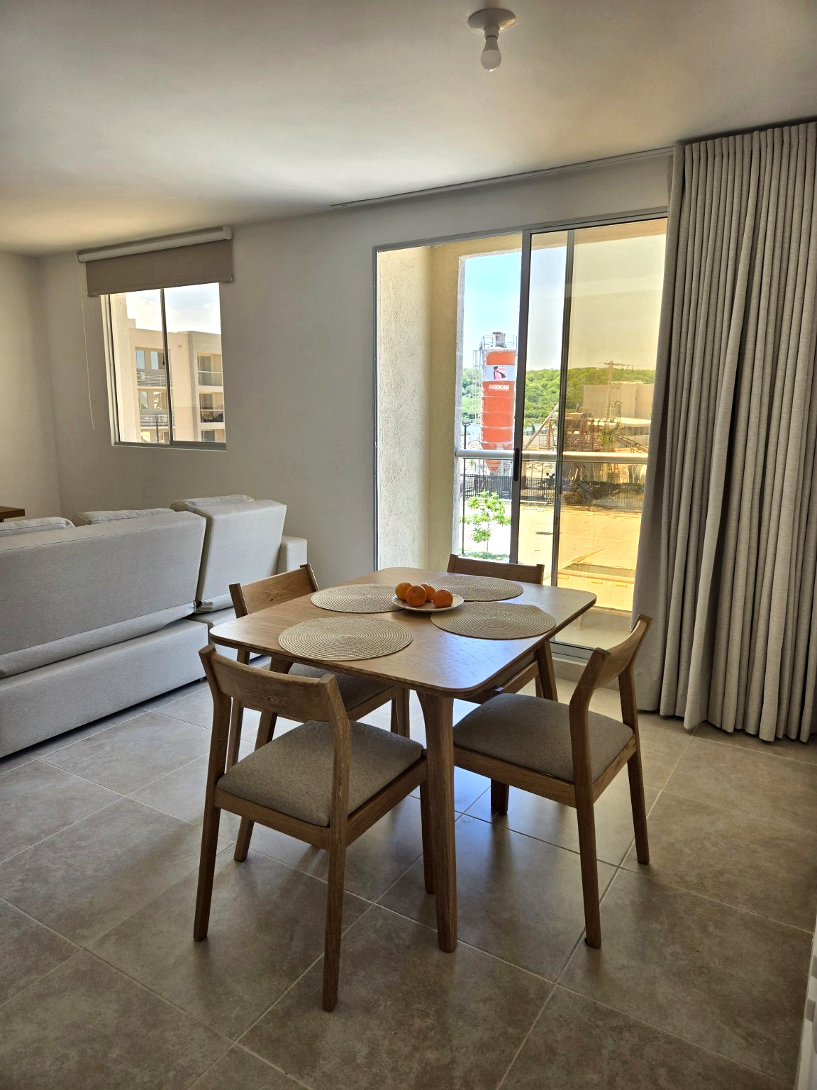 Capriella dining table beside the balcony doors