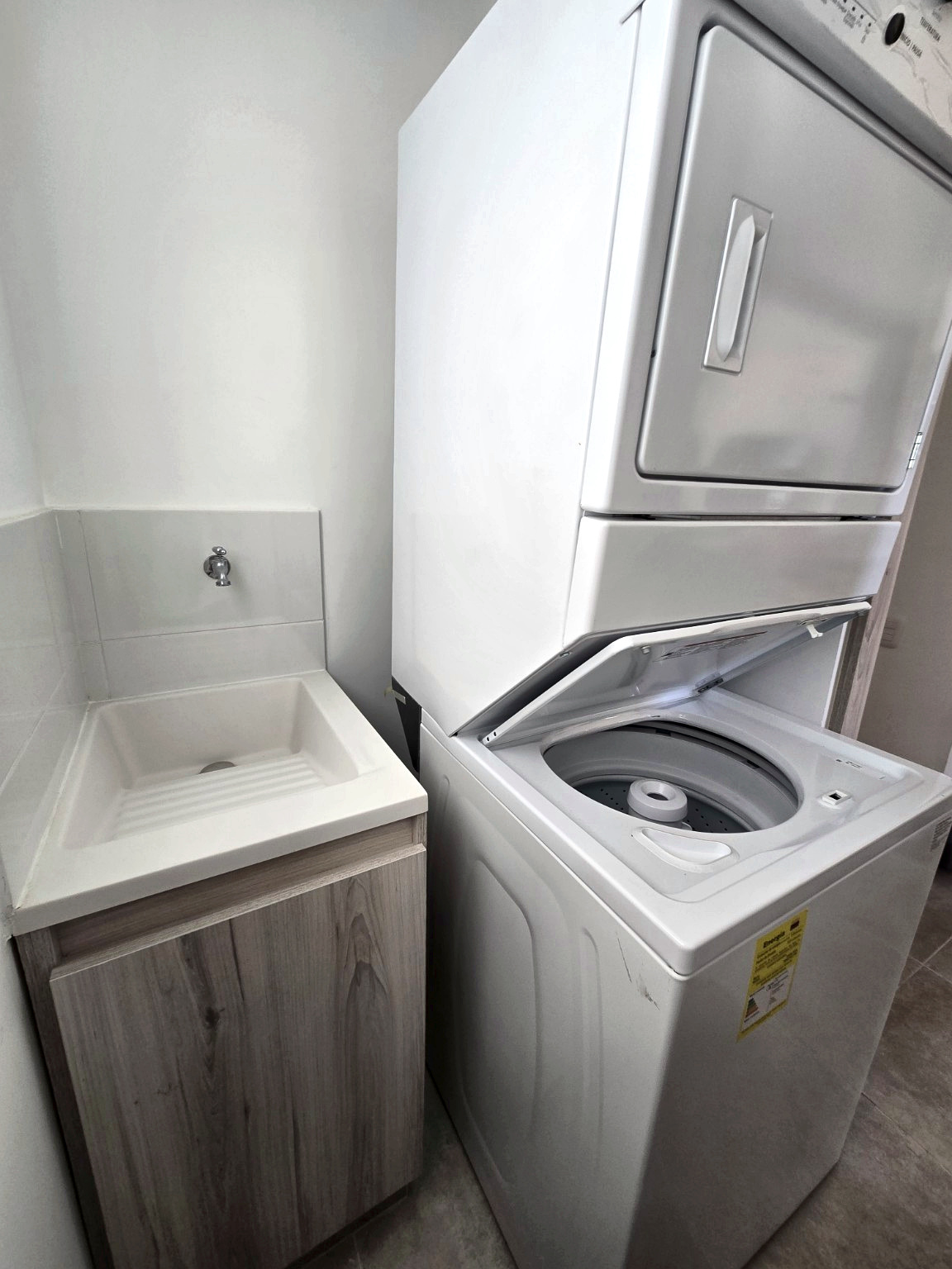 Capriella laundry sink and open washing machine