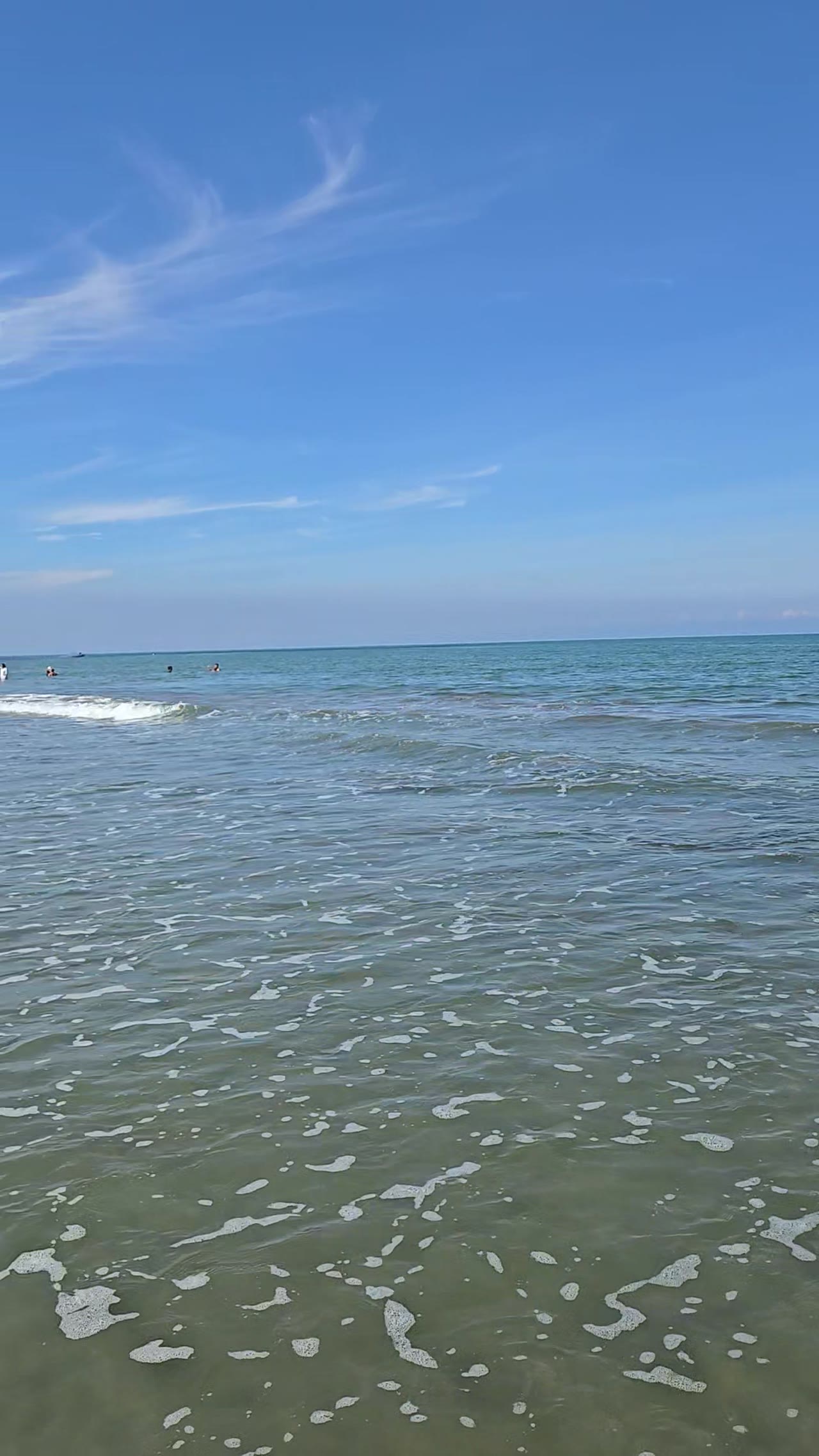 Shoreline at Playa Muralla looking out over the Caribbean, swimmers in the distance