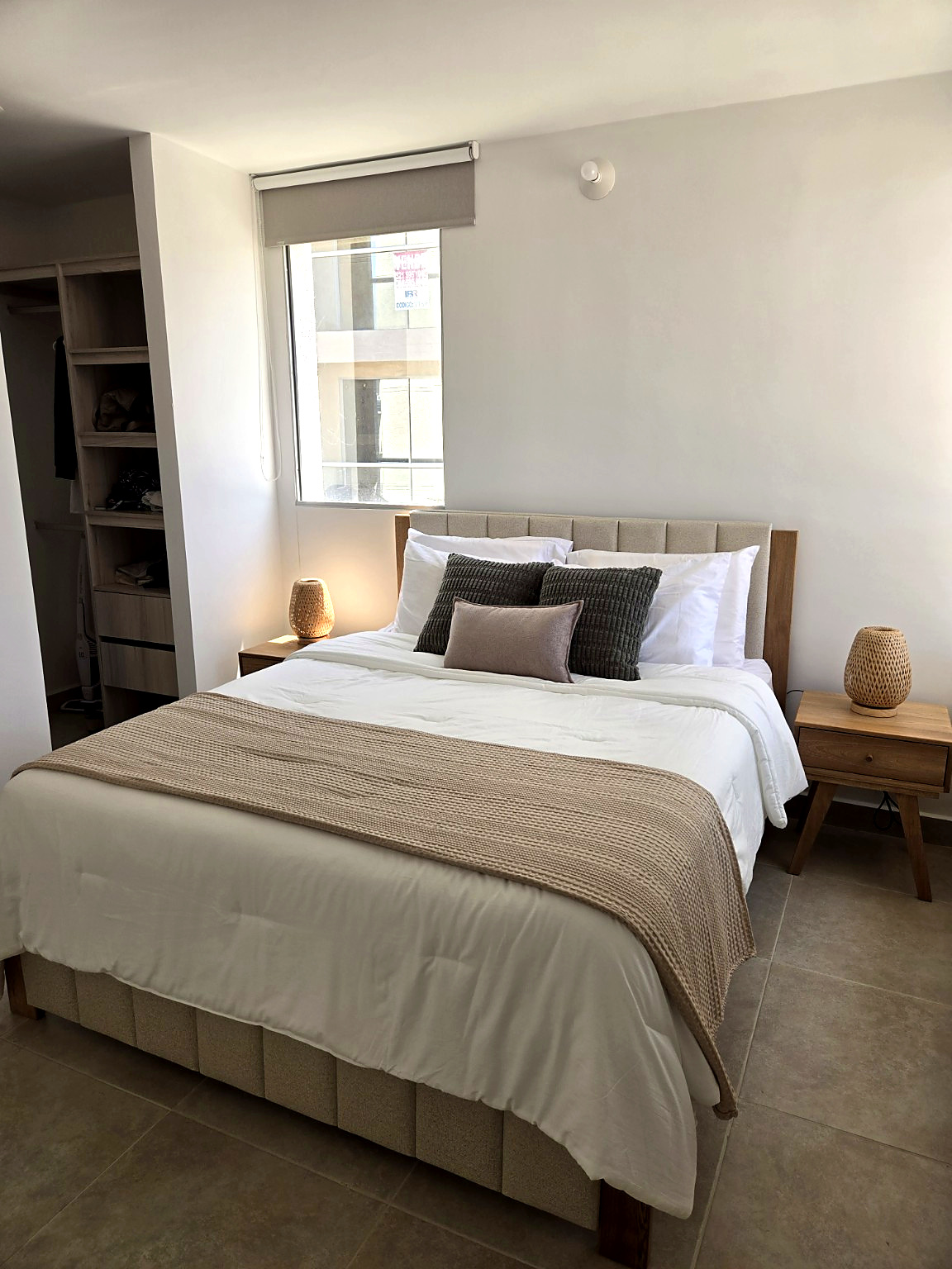 Capriella master bedroom with upholstered headboard, two nightstands and built-in wardrobe