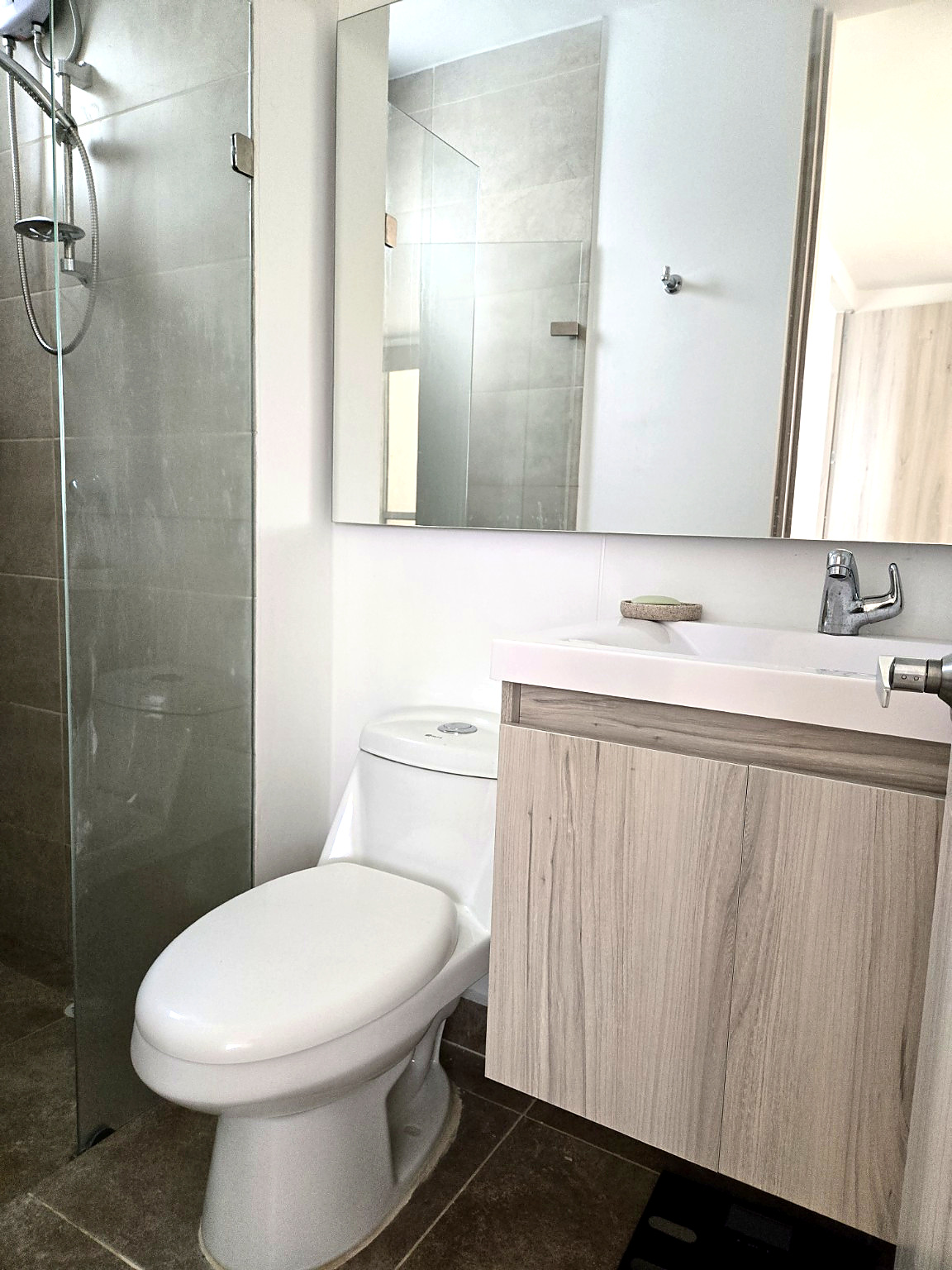 Capriella bathroom sink with floating wood vanity and frameless mirror