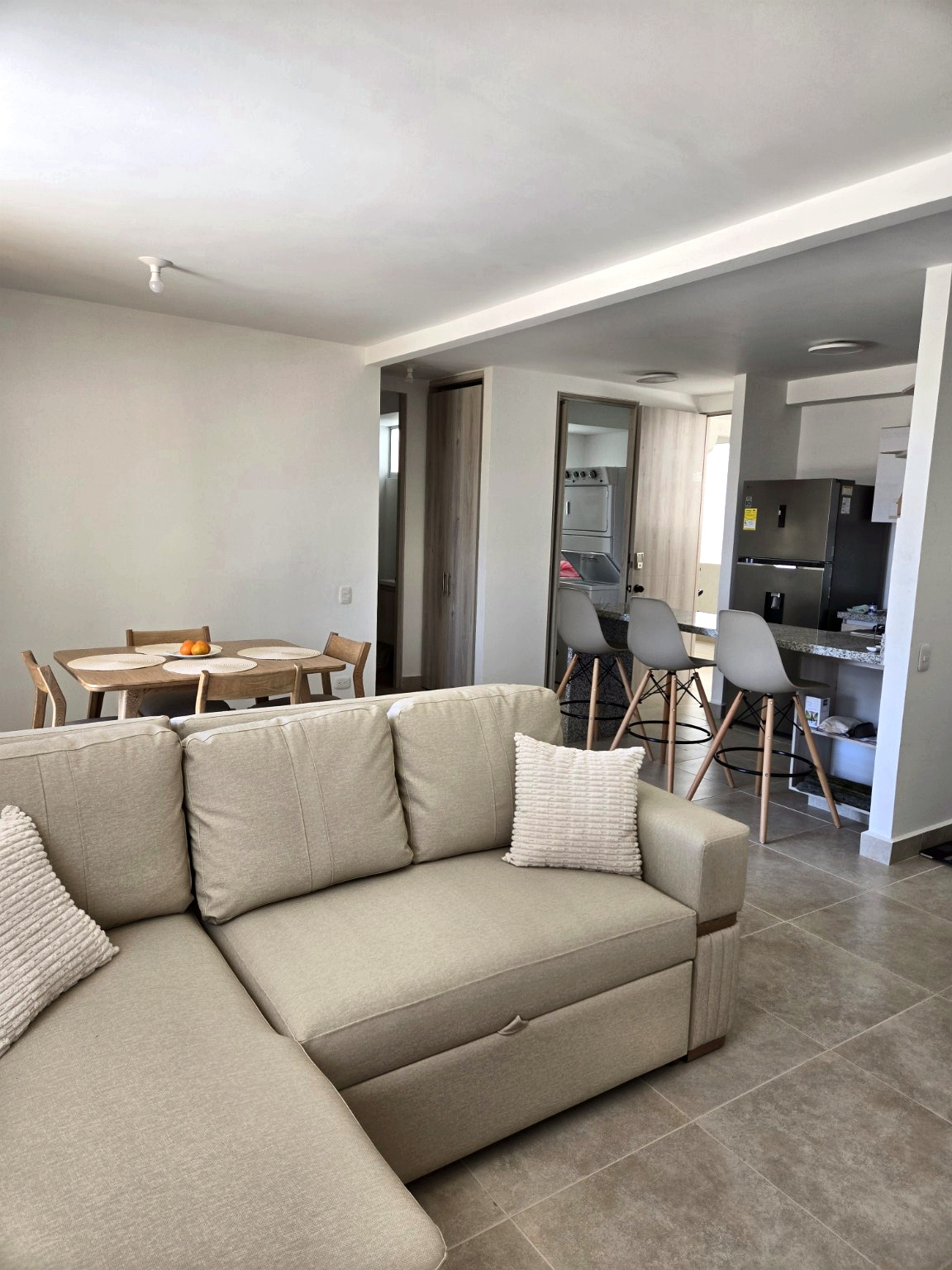 Capriella open living and dining areas with the kitchen in the background