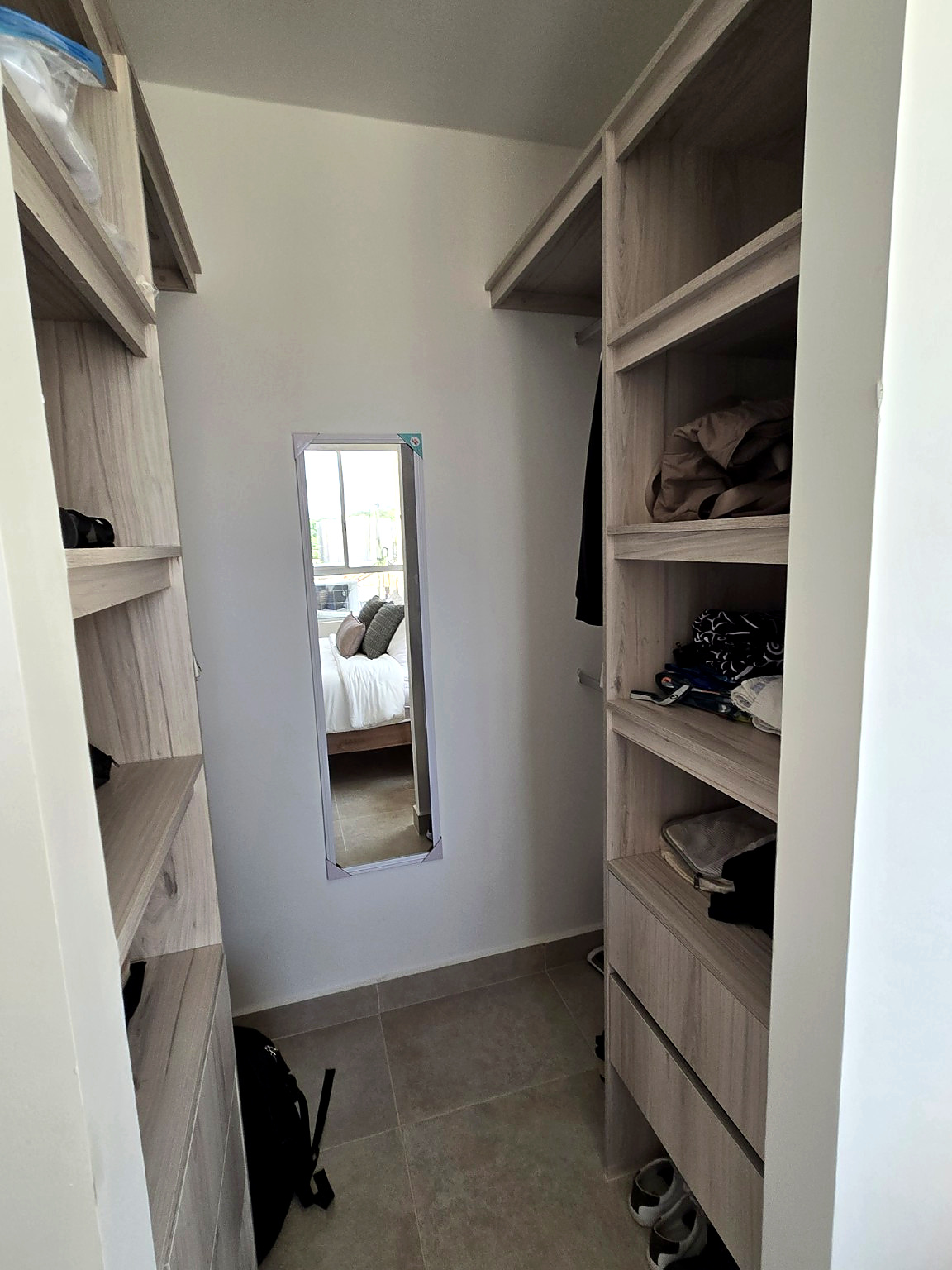 Capriella walk-in closet with open shelving, drawers and hanging rods